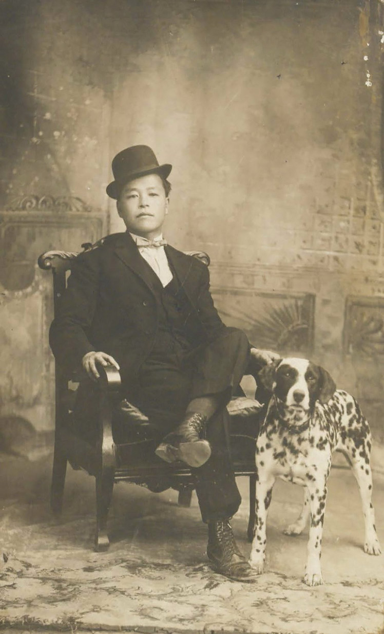 Man sitting in chair with dalmation